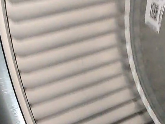 A furnace blower wheel with dust packed between its blades, before cleaning
