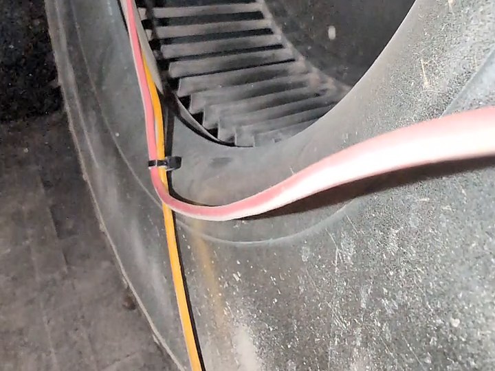 A furnace blower wheel and housing coated in dust before cleaning