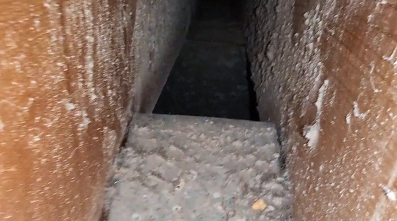 Dust and debris caked inside an air duct before cleaning